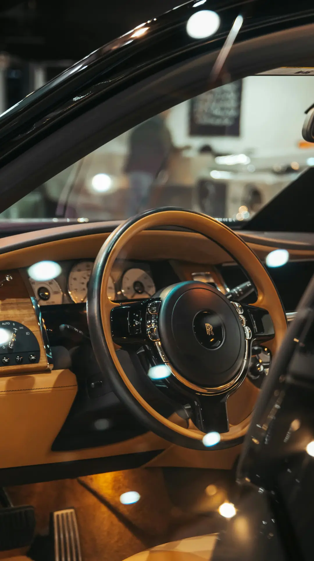 Premium leather steering wheel and digital dashboard lit by warm interior light
