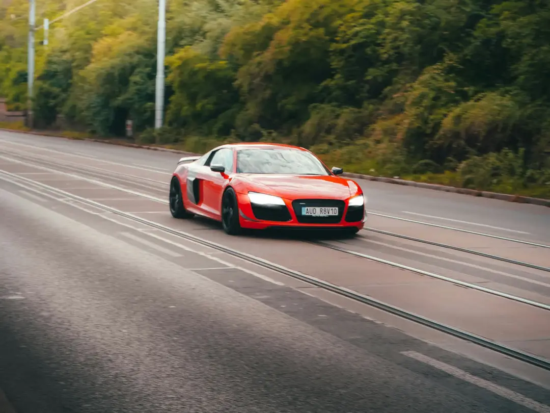 Red Audi R8 captured mid-pan on an open road
