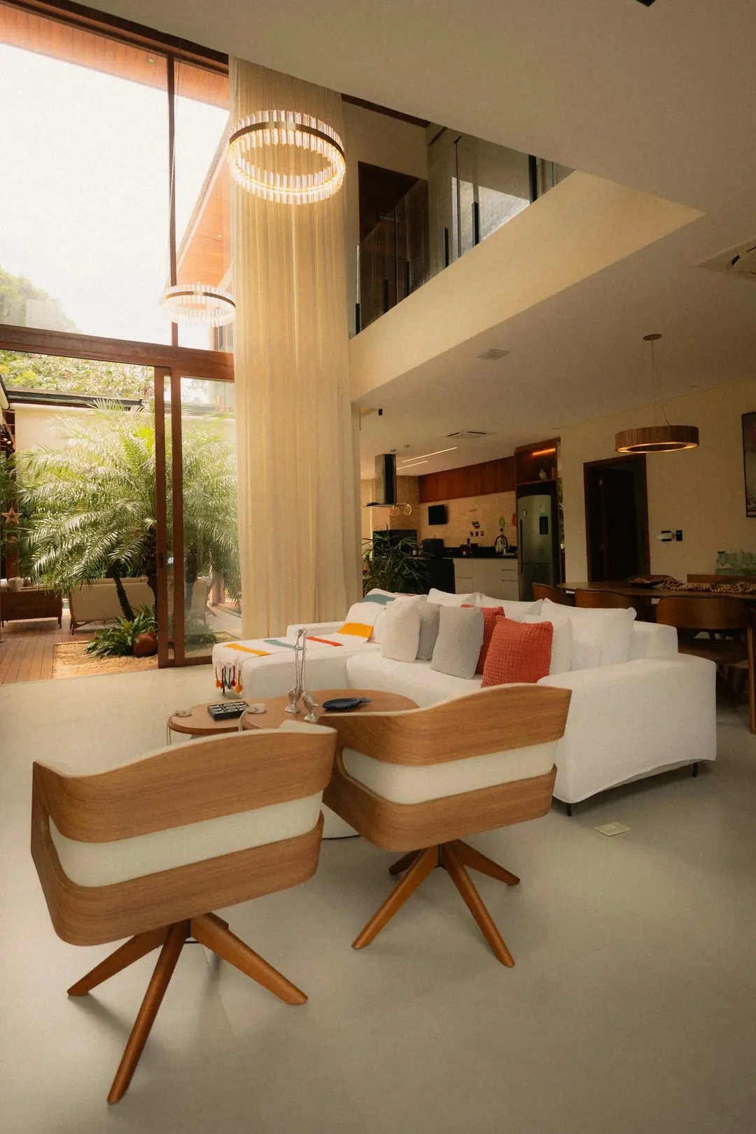 Luxurious modern living room bathed in natural light from floor-to-ceiling windows