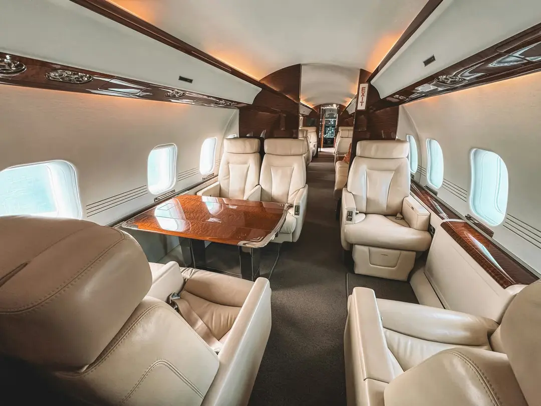Luxurious private jet cabin with leather seats and wood trim