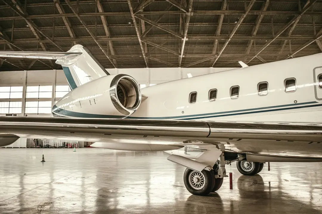 Private jet in a hangar, engine and tail detail